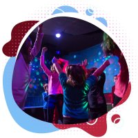 kids dancing inside with disco lights in the background