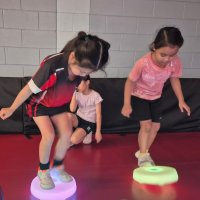 two girls play with glow pods